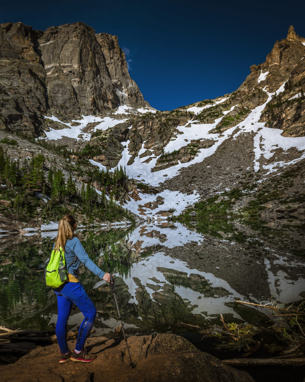 Kat views the reflection of Hallet Peak in a glassine Emerald Lake.