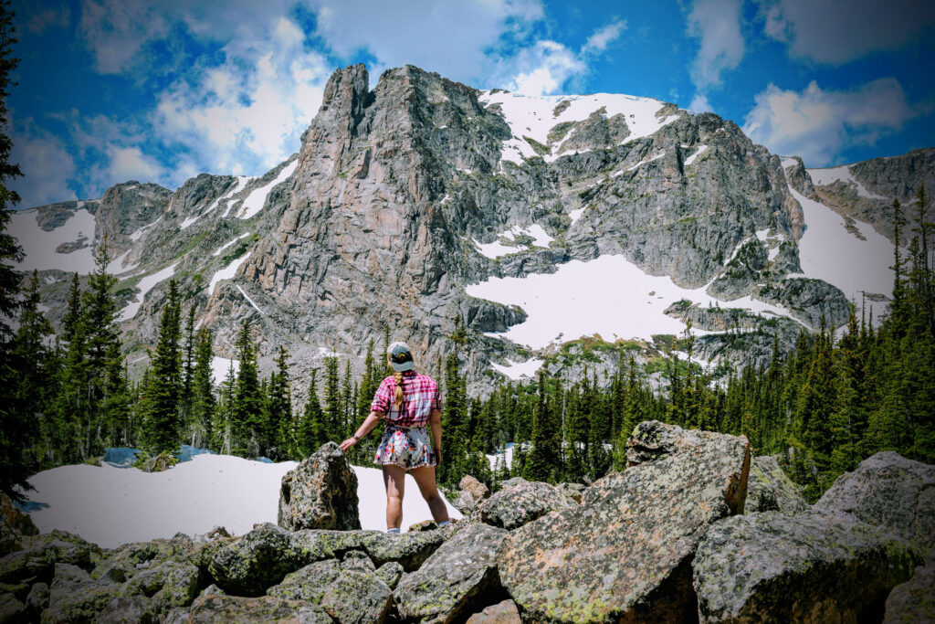 Kat stands before Notchtop Mountain on the trail to Lake Helene at Rocky Mountain National Park.