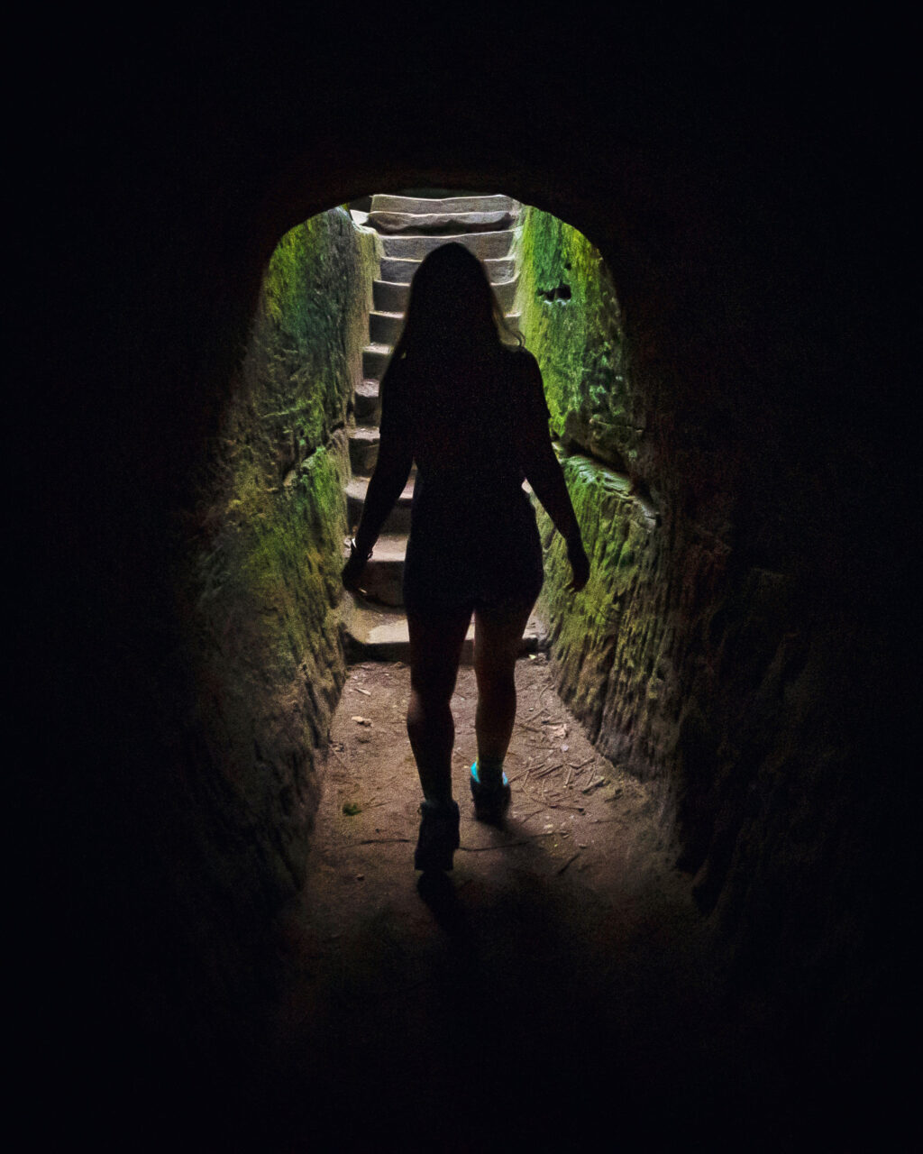 Silhouetted woman hiking through Old Man's Cave.