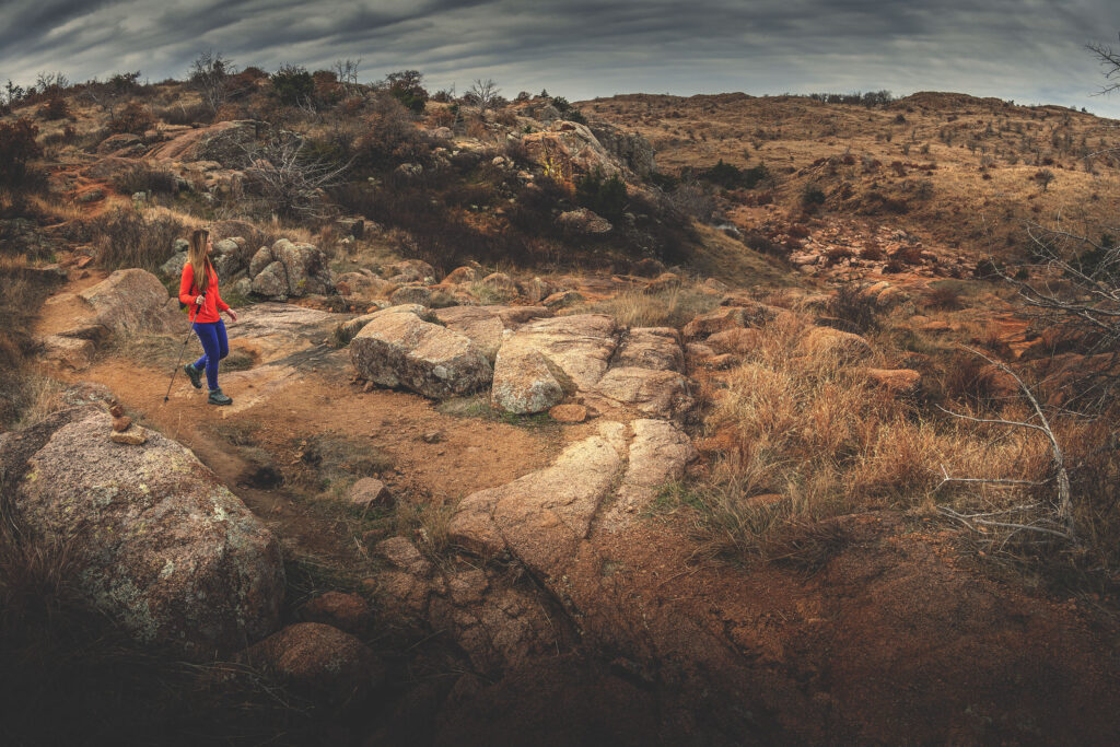 Woman hiking Bison Trail in the Oklahoma wilderness at Wichita Mountains Wildlife Refuge.